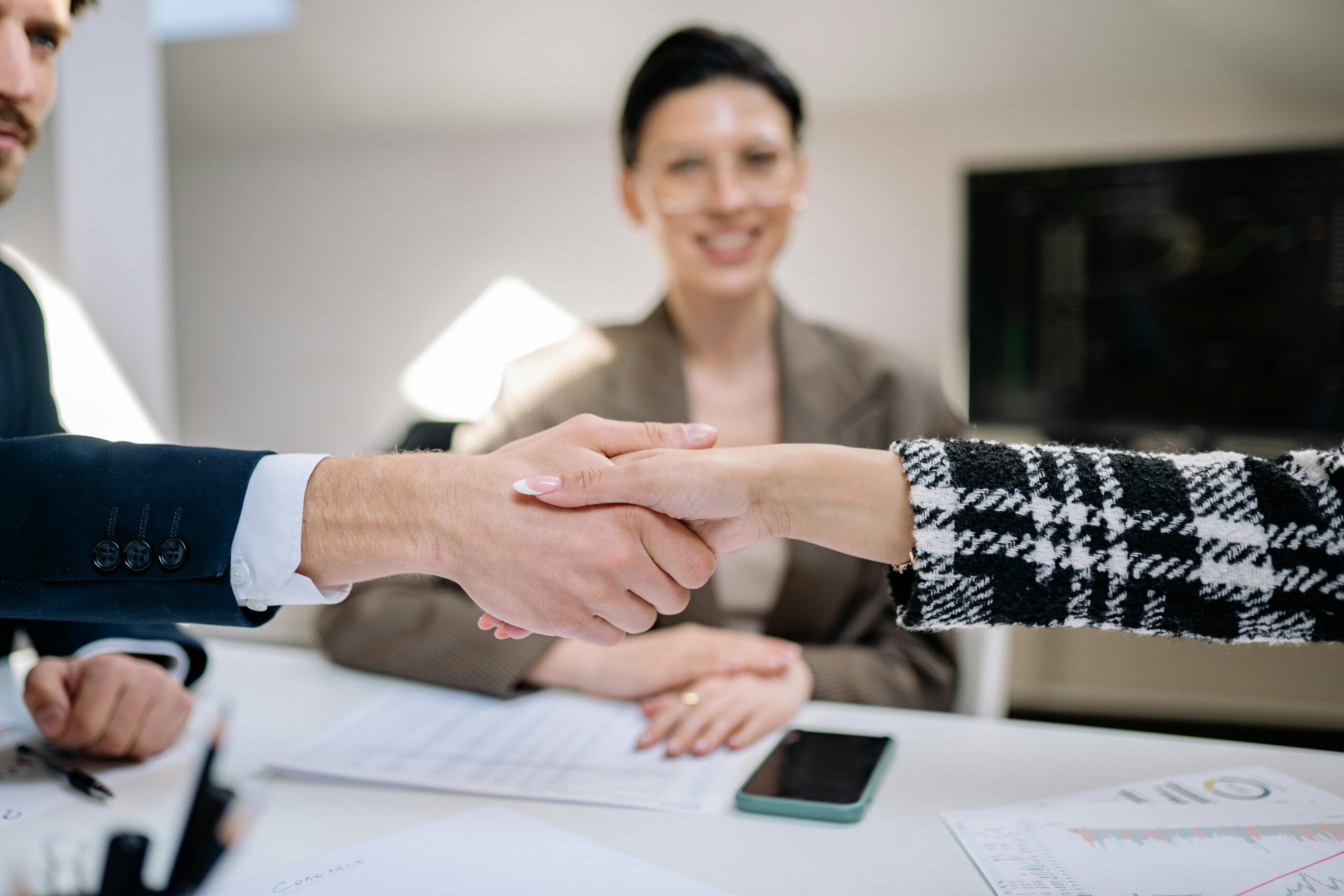 A marketing intern shaking hands with their supervisor